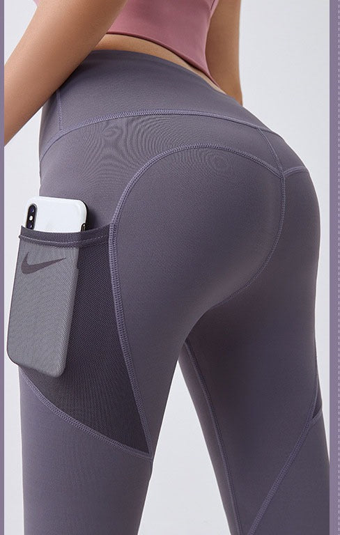 Woman wearing high-waist leggings with phone pocket