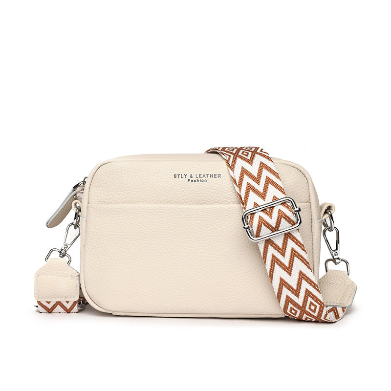 Small leather crossbody bag with patterned strap